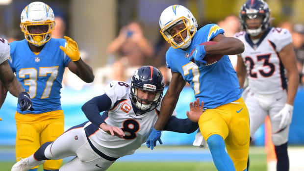 Los Angeles Chargers wide receiver Andre Roberts (7) returns the opening kick off before he is pushed out of bounds by Denver Broncos kicker Brandon McManus (8) in the first quarter of the game at SoFi Stadium.