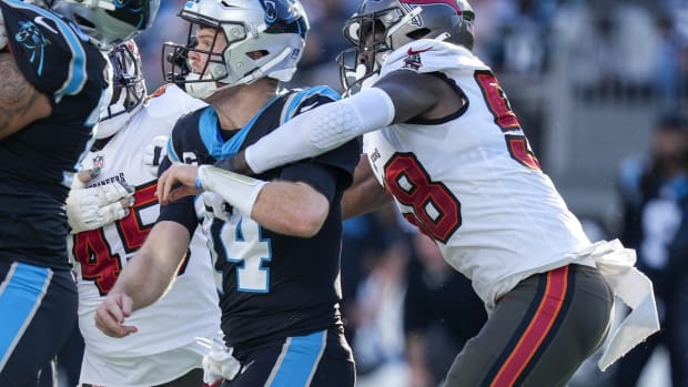 Dec 26, 2021; Charlotte, North Carolina, USA; Carolina Panthers quarterback Sam Darnold (14) is hit by Tampa Bay Buccaneers outside linebacker Shaquil Barrett (58) after the throw during the second quarter at Bank of America Stadium. Mandatory Credit: Jim Dedmon-USA TODAY Sports
