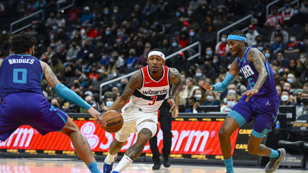 Jan 3, 2022; Washington, District of Columbia, USA; Washington Wizards guard Bradley Beal (3) dribbles between Charlotte Hornets forward Miles Bridges (0) and forward Jalen McDaniels (6) during the second half at Capital One Arena. Mandatory Credit: Brad Mills-USA TODAY Sports