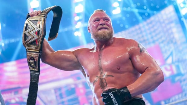 Brock Lesnar celebrates after winning the WWE championship at Day 1
