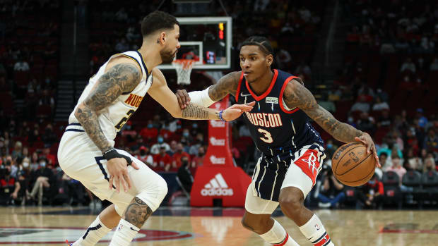 Houston Rockets guard Kevin Porter Jr. (3) controls the ball as Denver Nuggets guard Austin Rivers (25) defends during the first quarter at Toyota Center.