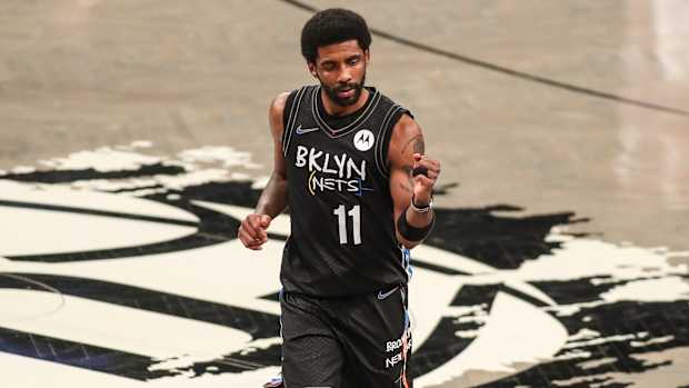 Kyrie Irving stands on the court.