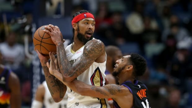 Jan 4, 2022; New Orleans, Louisiana, USA; New Orleans Pelicans forward Brandon Ingram (14) is defended by Phoenix Suns guard Cameron Payne (15) in the second half at the Smoothie King Center. Mandatory Credit: Chuck Cook-USA TODAY Sports