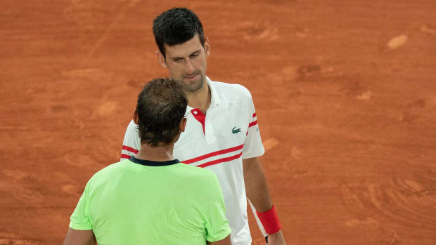 Novak Djokovic and Rafael Nadal at the net.