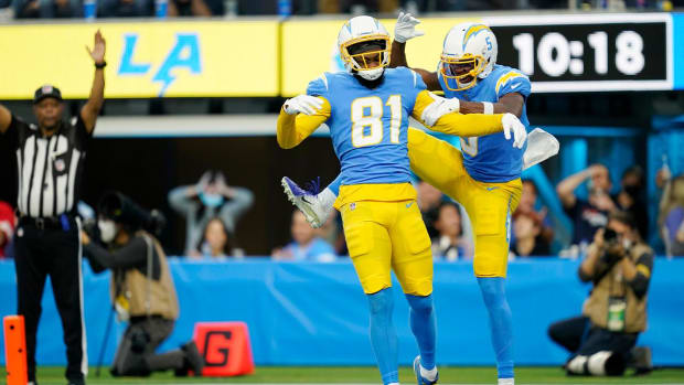 Los Angeles Chargers wide receiver Mike Williams (81) celebrates his touchdown catch with wide receiver Josh Palmer (5) during the second half of an NFL football game against the Denver Broncos Sunday, Jan. 2, 2022, in Inglewood, Calif.