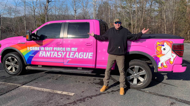 Kevin Ring stands next to his pink Ford F150.