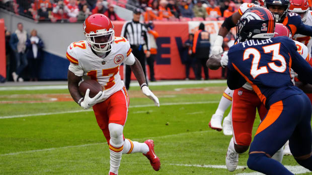 Jan 8, 2022; Denver, Colorado, USA; Kansas City Chiefs wide receiver Mecole Hardman (17) runs the ball against Denver Broncos cornerback Kyle Fuller (23) in the first quarter at Empower Field at Mile High. Mandatory Credit: Ron Chenoy-USA TODAY Sports