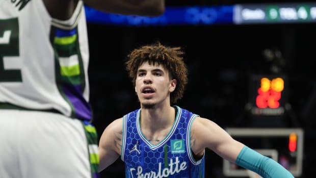 Jan 8, 2022; Charlotte, North Carolina, USA; Charlotte Hornets guard LaMelo Ball (2) defends an inbounds pass by Milwaukee Bucks forward Khris Middleton (22) during the second period at the Spectrum Center. Mandatory Credit: Jim Dedmon-USA TODAY Sports