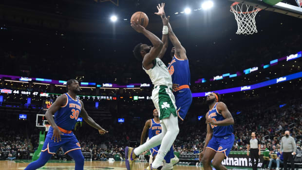 Jan 8, 2022; Boston, Massachusetts, USA; Boston Celtics guard Jaylen Brown (7) shoots the ball over New York Knicks guard Alec Burks (18) during the second half at TD Garden. Mandatory Credit: Bob DeChiara-USA TODAY Sports