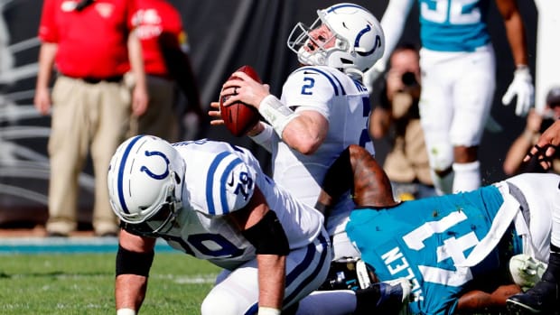 Indianapolis Colts quarterback Carson Wentz (2) is sacked by Jacksonville Jaguars outside linebacker Josh Allen (41) during the first half of an NFL football game, Sunday, Jan. 9, 2022, in Jacksonville, Fla.