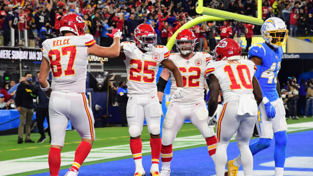 Dec 16, 2021; Inglewood, California, USA; Kansas City Chiefs running back Clyde Edwards-Helaire (25) celebrates with tight end Travis Kelce (87) and wide receiver Tyreek Hill (10) his two point conversion score against the Los Angeles Chargers during the second half at SoFi Stadium. Mandatory Credit: Gary A. Vasquez-USA TODAY Sports