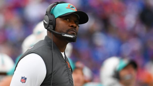 Dolphins coach Brian Flores looks up at the scoreboard during a game