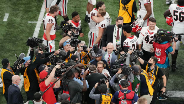 Nick Saban and Kirby Smart in the media scrum after the 2021–22 national title game.