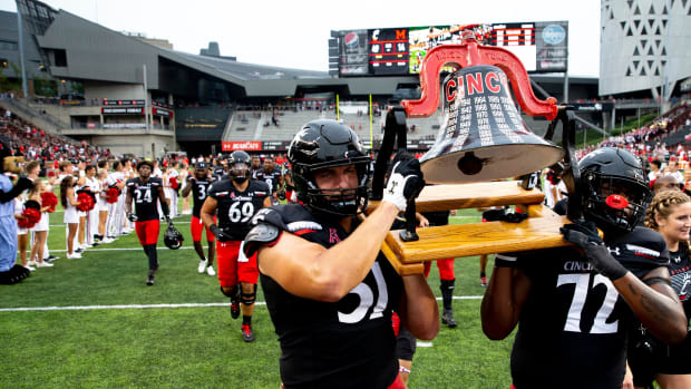Cincinnati Bearcats offensive lineman Lorenz Metz (51) and Cincinnati Bearcats offensive lineman James Tunstall (72) carry the Victory Bell after the NCAA football game on Saturday, Sept. 4, 2021, at Nippert Stadium in Cincinnati. Cincinnati Bearcats defeated Miami Redhawks 49-14. Cincinnati Bearcats Miami Redhawks