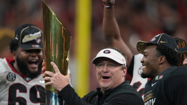Kirby Smart holding up the national championship trophy.