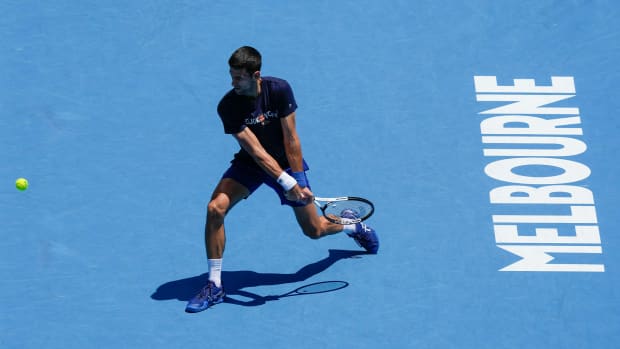 Defending men's champion Serbia's Novak Djokovic practices on Rod Laver Arena ahead of the Australian Open tennis championship in Melbourne, Australia, Wednesday, Jan. 12, 2022.