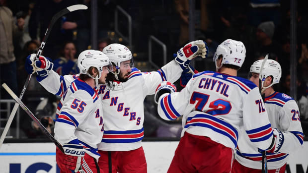 Jan 10, 2022; Los Angeles, California, USA; New York Rangers center Mika Zibanejad (93) celebrates with defenseman Ryan Lindgren (55) center Filip Chytil (72) and defenseman Adam Fox (23) his goal scored against the Los Angeles Kings during the third period at Crypto.com Arena. Mandatory Credit: Gary A. Vasquez-USA TODAY Sports