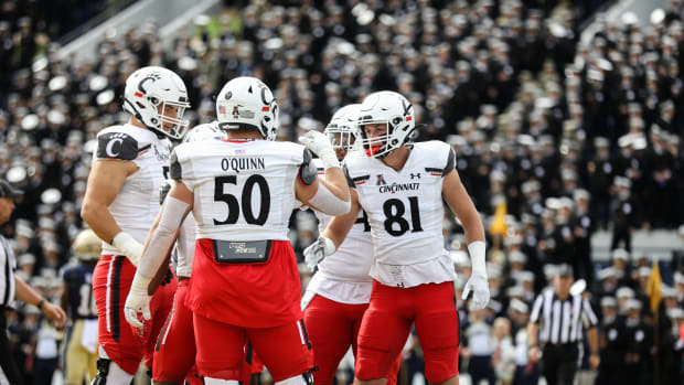 UC's Josh Whyle (81) celebrates with the team after scoring his team's first touchdown of the UC Bearcats vs. Navy Midshipmen game at Navy-Marine Corps Memorial Stadium on Saturday October 23, 2021. The Bearcats lead the game at halftime with a score of 13-10.