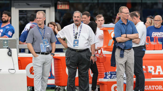 Aug 14, 2021; East Rutherford, New Jersey, USA; New York Giants co-director of player personnel Tim McDonnell, left, general manager Dave Gettleman, center, and owner John Mara looks on before the game against the New York Jets at MetLife Stadium.