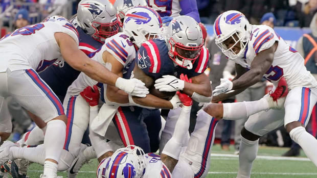 New England Patriots running back Damien Harris (37) drives through the Buffalo Bills for his third touchdown of the day during the second half of an NFL football game, Sunday, Dec. 26, 2021, in Foxborough, Mass.