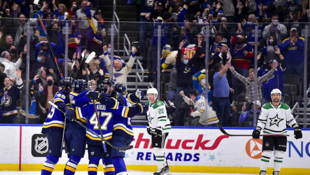 Jan 9, 2022; St. Louis, Missouri, USA; St. Louis Blues center Jordan Kyrou (25) celebrates with teammates after scoring the game winning goal against the Dallas Stars during the third period at Enterprise Center. Mandatory Credit: Jeff Curry-USA TODAY Sports