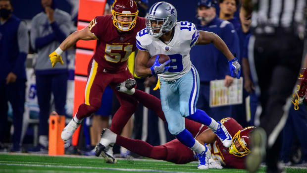 Dec 26, 2021; Arlington, Texas, USA; Dallas Cowboys wide receiver Amari Cooper (19) eludes the tackle of Washington Football Team outside linebacker David Mayo (51) during the first quarter at AT&T Stadium.