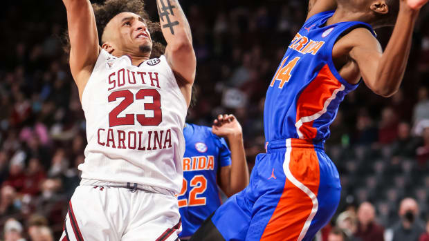 South Carolina Gamecocks guard Devin Carter (23) shoots over Florida Gators guard Kowacie Reeves (14) in the first half at Colonial Life Arena.