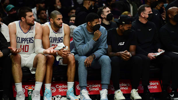 Clippers center Ivica Zubac (40) forward Nicolas Batum (33) guard Paul George and forward Kawhi Leonard watch game action against the Denver Nuggets.
