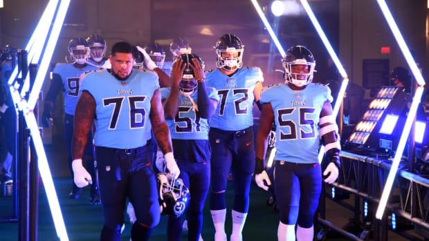 Tennessee Titans offensive guard Rodger Saffold (76) and Tennessee Titans inside linebacker Jayon Brown (55) lead players to the field before the game against the Indianapolis Colts at Nissan Stadium.