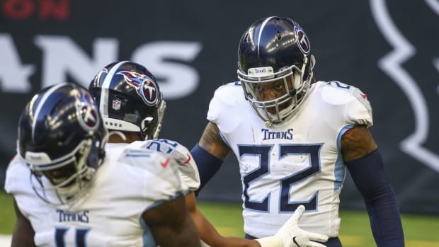 Jan 3, 2021; Houston, Texas, USA; Tennessee Titans running back Derrick Henry (22) celebrates with teammates after scoring a touchdown during the second quarter against the Houston Texans at NRG Stadium. Mandatory Credit: Troy Taormina-USA TODAY Sports