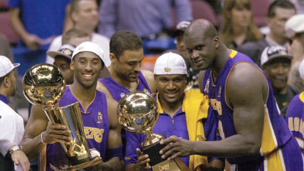 (left to right) Los Angeles Lakers Kobe Bryant, Lindsay Hunter and Shaquille O'Neal hold championship trophies after winning Game 4 of the NBA Finals at The Meadowlands.