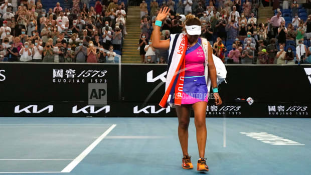 Naomi Osaka walks off Australian Open court after loss to Amanda Anisimova.