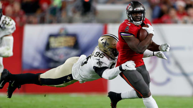 Dec 19, 2021; Tampa, Florida, USA; Tampa Bay Buccaneers running back Leonard Fournette (7) is tackled by New Orleans Saints defensive end Carl Granderson (96) in the first quarter at Raymond James Stadium.