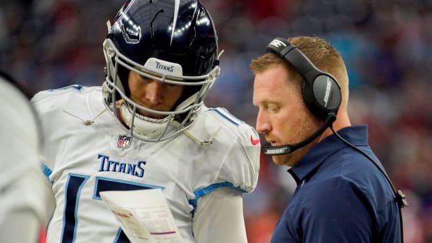 Tennessee Titans quarterback Ryan Tannehill (17) checks in with offensive coordinator Todd Downing during the first quarter at NRG Stadium Sunday, Jan. 9, 2022 in Houston, Texas.
