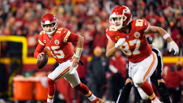 Patrick Mahomes looking to pass the ball while Travis Kelce runs a route.