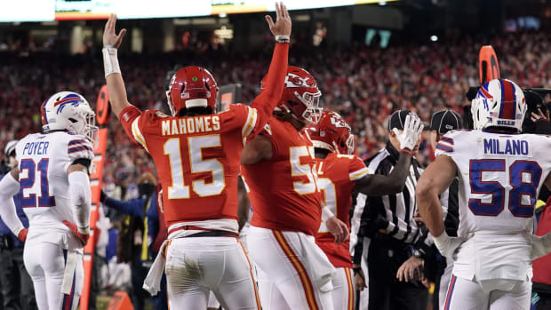 Jan 23, 2022; Kansas City, Missouri, USA; Kansas City Chiefs quarterback Patrick Mahomes (15) signals a touchdown after his diving stretch to the end zone pylon against the Buffalo Bills during the first quarter in the AFC Divisional playoff football game at GEHA Field at Arrowhead Stadium. Mandatory Credit: Denny Medley-USA TODAY Sports