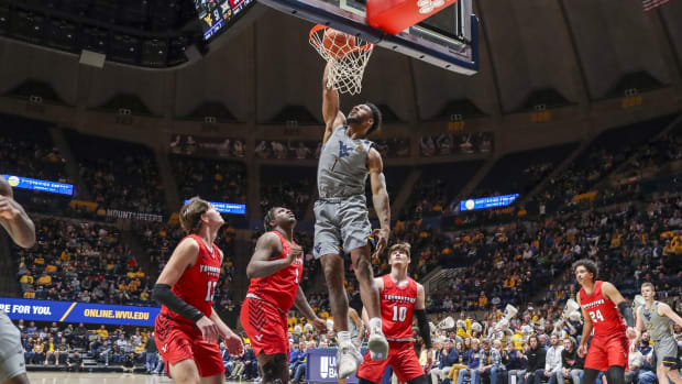 Dec 22, 2021; Morgantown, West Virginia, USA; West Virginia Mountaineers forward Pauly Paulicap (1) dunks the ball during the second half against the Youngstown State Penguins at WVU Coliseum.