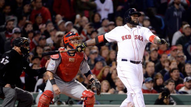 Oct 23, 2013; Boston, MA, USA; Boston Red Sox designated hitter David Ortiz drives in a run with a sacrifice fly in the second inning against the St. Louis Cardinals during game one of the MLB baseball World Series at Fenway Park. Mandatory Credit: Robert Deutsch-USA TODAY Sports