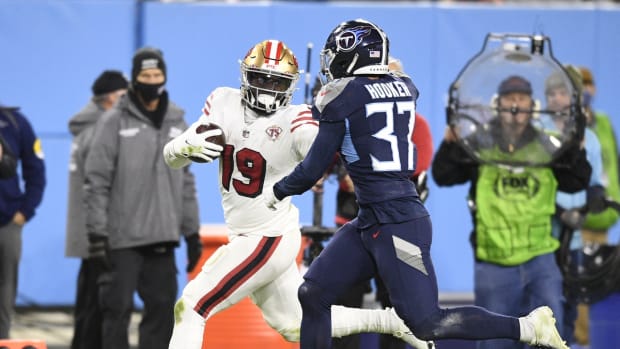 Dec 23, 2021; Nashville, Tennessee, USA; San Francisco 49ers wide receiver Deebo Samuel (19) stiff arms Tennessee Titans safety Amani Hooker (37) during the second half at Nissan Stadium. Mandatory Credit: Steve Roberts-USA TODAY Sports