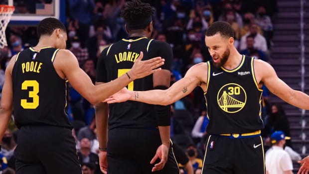 Jan 25, 2022; San Francisco, California, USA; Golden State Warriors guard Jordan Poole (3) high fives guard Stephen Curry (30) as a time out is called by the Dallas Mavericks during the third quarter at Chase Center. Mandatory Credit: Kelley L Cox-USA TODAY Sports