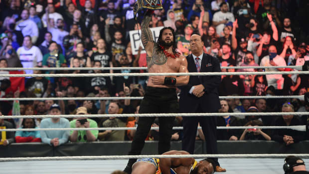 WWE Universal Champion Roman Reigns (black attire) along with his special counsel Paul Heyman (suit) celebrate the win over WWE World Heavyweight Champion Big E (colored attire) during their singles m...