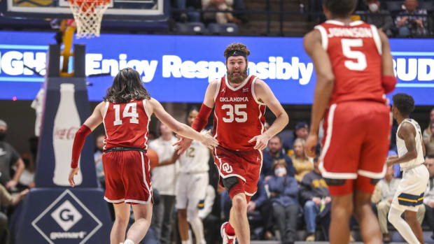 Jan 26, 2022; Morgantown, West Virginia, USA; Oklahoma Sooners forward Tanner Groves (35) celebrates with Oklahoma Sooners guard Bijan Cortes (14) during the second half at WVU Coliseum.