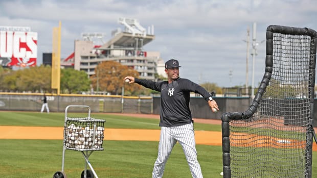 Dillon Lawson throws batting practice outside