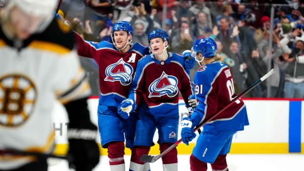 Jan 26, 2022; Denver, Colorado, USA; Colorado Avalanche defenseman Cale Makar (8) and right wing Mikko Rantanen (96) and center Nazem Kadri (91) celebrate the overtime win against the Boston Bruins at Ball Arena. Mandatory Credit: Ron Chenoy-USA TODAY Sports