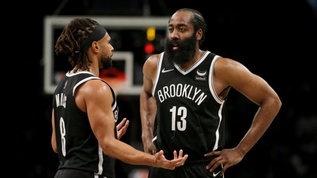 Brooklyn Nets guard Patty Mills (8) talks to guard James Harden (13) during the third quarter against the Los Angeles Lakers at Barclays Center.