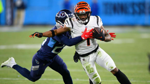 Tennessee Titans cornerback Janoris Jenkins (20) tackles Cincinnati Bengals wide receiver Ja'Marr Chase (1) during the second half of an NFL divisional round playoff football game, Saturday, Jan. 22, 2022, in Nashville, Tenn.
