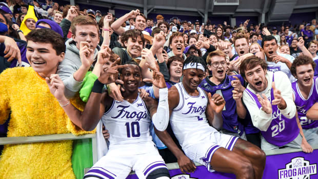 Jan 29, 2022; Fort Worth, Texas, USA; TCU Horned Frogs forward Emanuel Miller (2) and guard Damion Baugh (10) celebrate with fans after the game against the LSU Tigers at Ed and Rae Schollmaier Arena