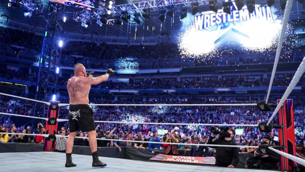 Brock Lesnar points to the WrestleMania sign after winning the Royal Rumble