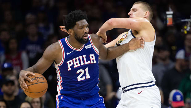 Philadelphia 76ers center Joel Embiid (21) controls the ball against Denver Nuggets center Nikola Jokic.