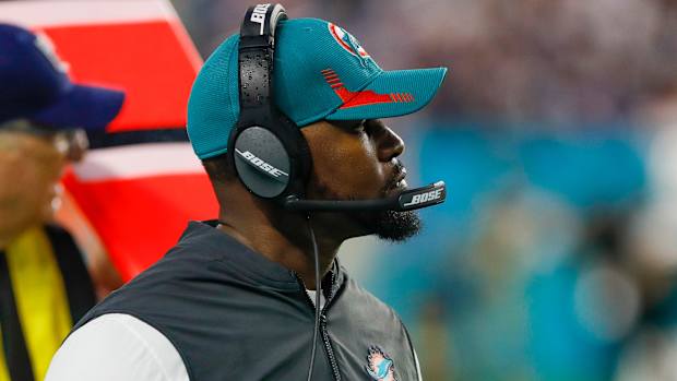 Former Dolphins head coach Brian Flores looks on while coaching.